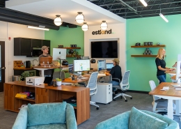 Wide shot of Estland's new marketing and branding office in Harrisonburg, VA. Pictured with three team members working at work stations.