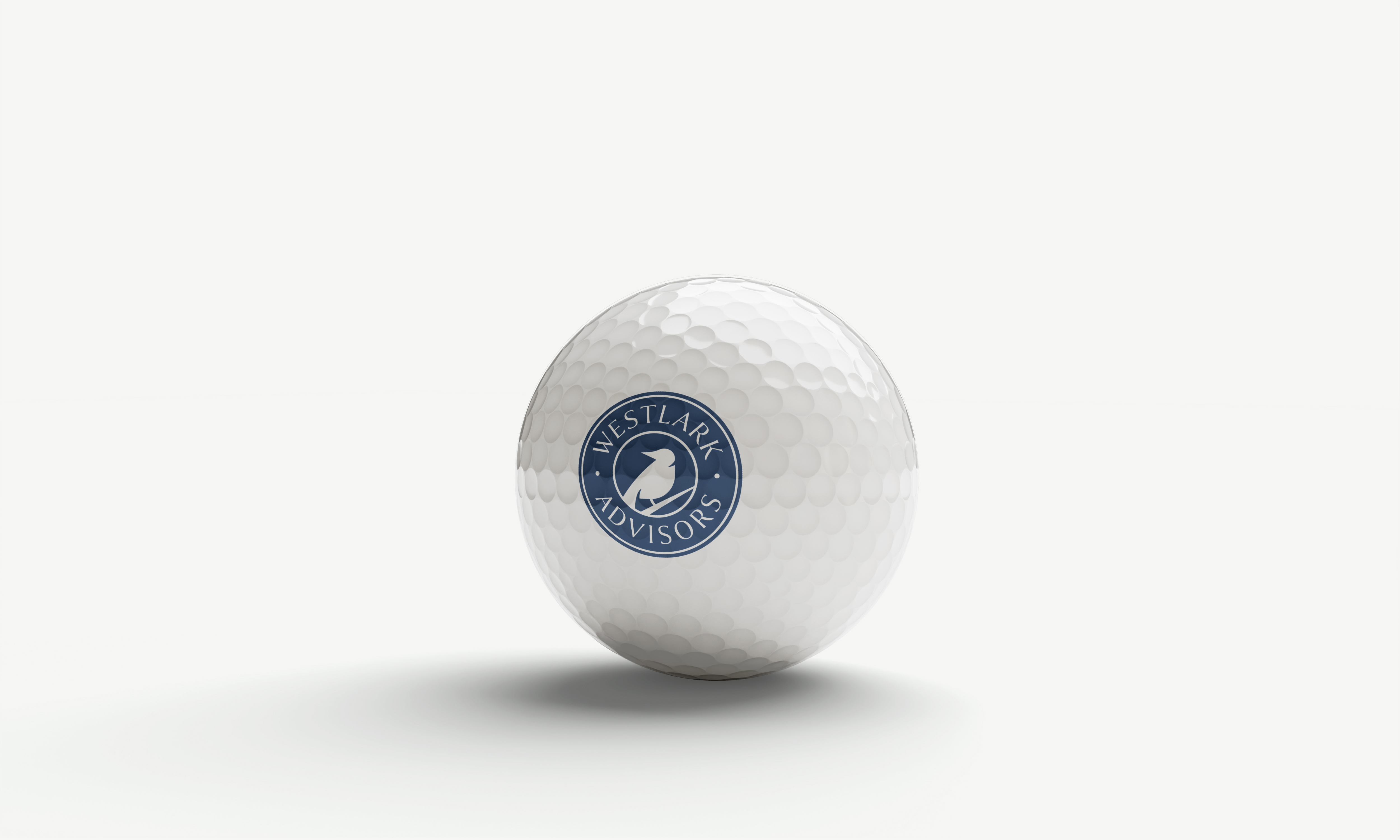 Westlark Advisors rebrand logo on a golf ball.