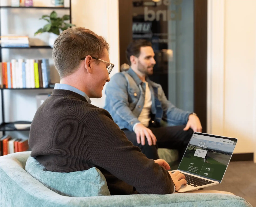 Web Developer action shot Estland web developer reviewing a recently developed web site in a collaborative setting.
