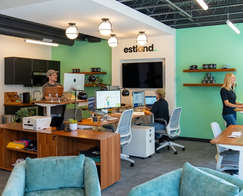 Wide shot of Estland's new marketing and branding office in Harrisonburg, VA. Pictured with three team members working at work stations.