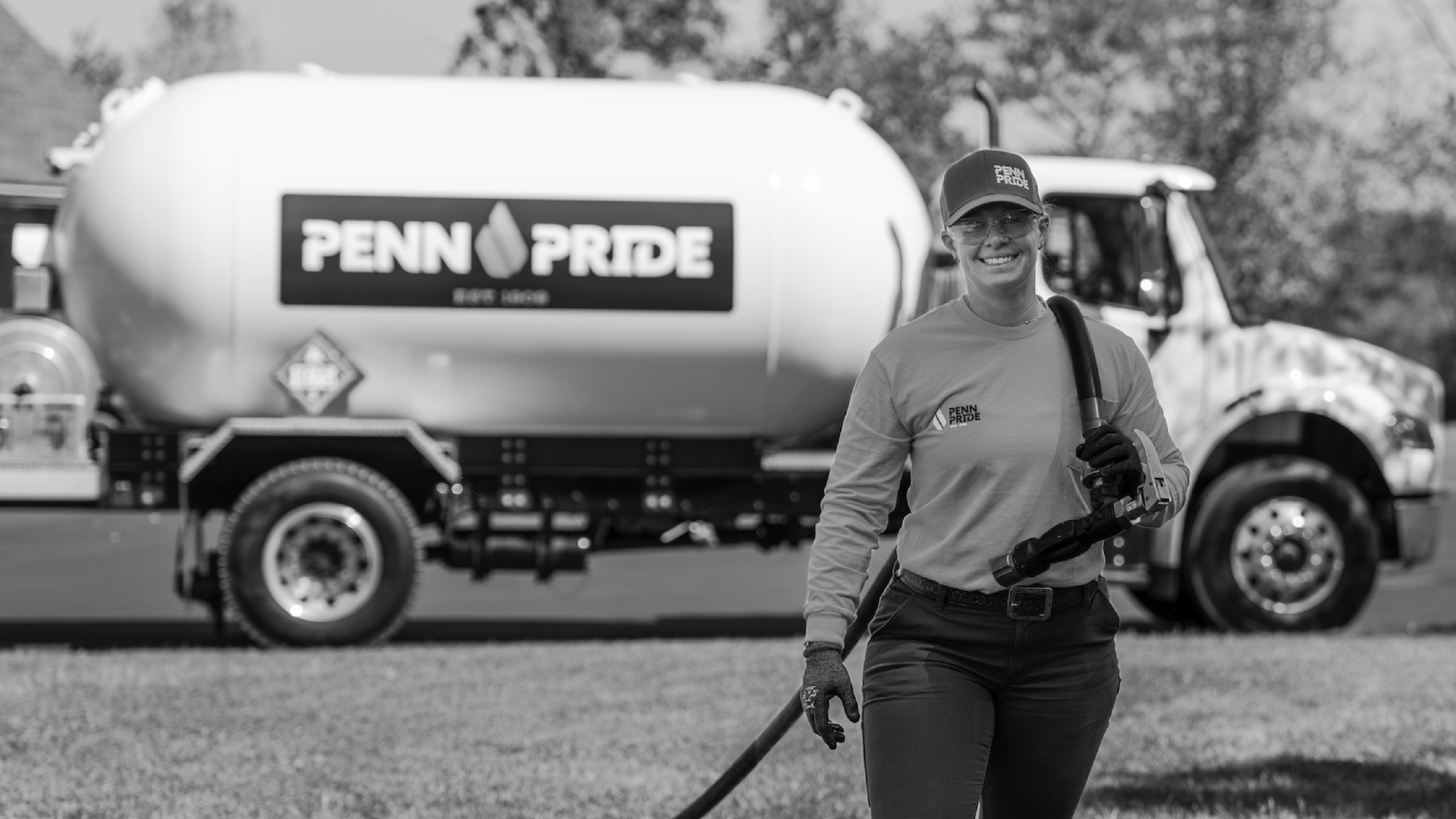 Alex Vespico, VP of Penn Pride, carrying a propane hose away from a Penn Pride truck.