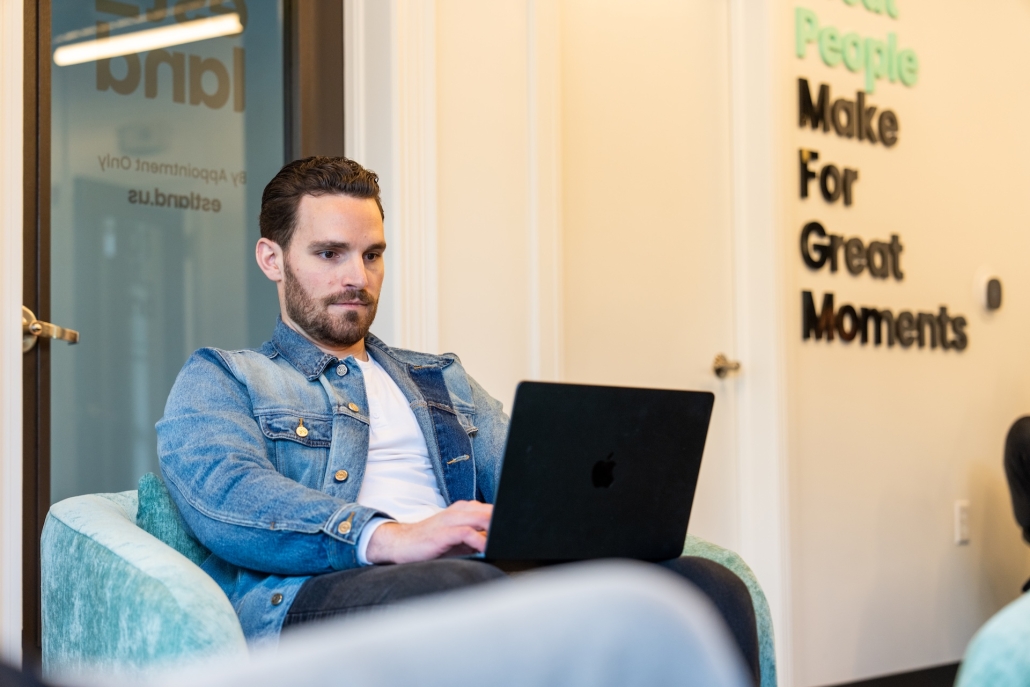 Estland team member on laptop in office