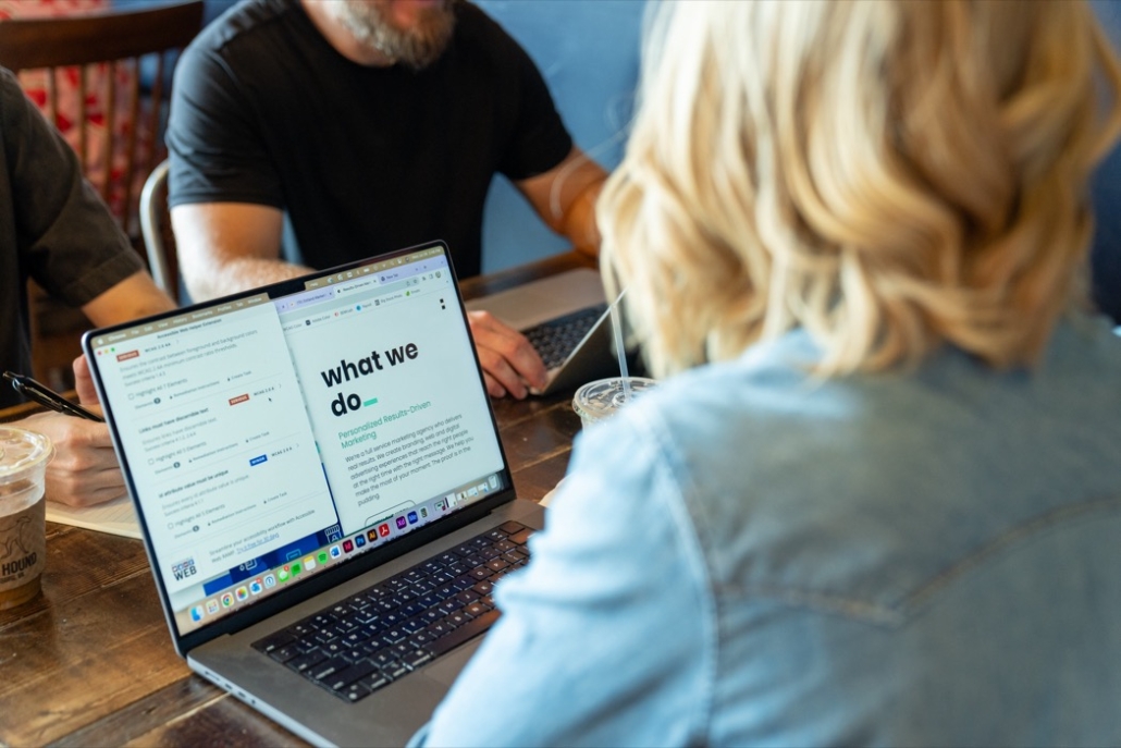 People sitting at a table with laptops