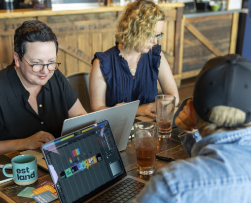 A group of people working on laptops at a table.